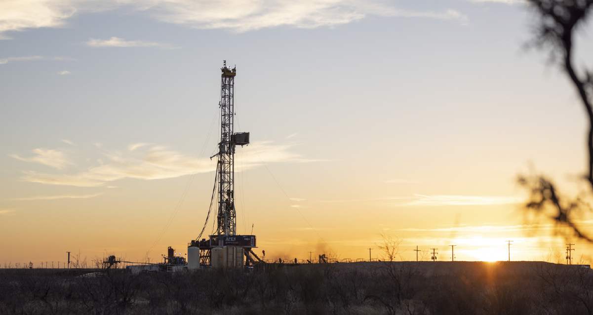 Sunset behind oil drill